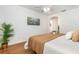 Bright bedroom features wood-look floors and an arched doorway, with a green plant at 1345 24Th St, Sarasota, FL 34234