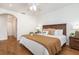 A cozy bedroom with a decorative headboard, tray with wine glasses, and a ceiling fan at 1345 24Th St, Sarasota, FL 34234