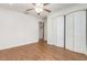 A bedroom boasts wood-look floors, a ceiling fan, and ample closet space at 1345 24Th St, Sarasota, FL 34234