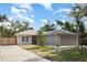 Well-kept single-story home boasts a two-car garage, complemented by fresh landscaping and a vibrant green lawn at 1345 24Th St, Sarasota, FL 34234