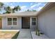 Inviting front entrance with well-maintained landscaping, featuring cacti and white rock against a freshly painted exterior at 1345 24Th St, Sarasota, FL 34234