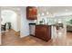 A stylish kitchen features wood-look tile floors, stainless dishwasher, and hanging lights at 1345 24Th St, Sarasota, FL 34234