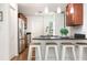 Modern kitchen with dark countertops, stainless steel appliances, barstool seating, and stylish pendant lighting at 1345 24Th St, Sarasota, FL 34234