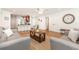Spacious living room featuring stylish furnishings, wood-look flooring, and a seamless transition to the open-concept kitchen at 1345 24Th St, Sarasota, FL 34234