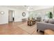 Open-concept living room featuring stylish furnishings, wood-look tile, a ceiling fan, and backyard access at 1345 24Th St, Sarasota, FL 34234