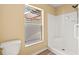 Clean bathroom with a walk-in shower and a window offering natural light at 1399 Shields St, Punta Gorda, FL 33980
