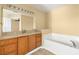 Spacious bathroom with a bathtub, vanity, and ample storage space at 1399 Shields St, Punta Gorda, FL 33980