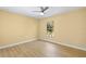 Bright bedroom features wood-look floors, yellow walls, and a window with a lush outdoor view at 1399 Shields St, Punta Gorda, FL 33980