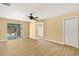 Inviting bedroom with wood floors, a ceiling fan, and sliding glass doors leading to the screened patio at 1399 Shields St, Punta Gorda, FL 33980