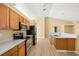 Kitchen showcases stainless steel appliances, white countertops, and natural wood cabinets at 1399 Shields St, Punta Gorda, FL 33980