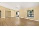 Bright living room featuring wood flooring, a ceiling fan and sliding glass door to the pool at 1399 Shields St, Punta Gorda, FL 33980