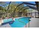 Screened pool featuring spa, tile border, and a concrete deck underneath a screened lanai at 1399 Shields St, Punta Gorda, FL 33980