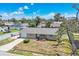 Aerial view of a single-story home featuring a well-maintained lawn, a one-car garage and a nearby pool at 1533 Olympia Rd, Venice, FL 34293