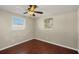 An additional bedroom boasts wood floors, ample light and ceiling fan at 1533 Olympia Rd, Venice, FL 34293