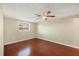 Bright bedroom with hardwood floors, ceiling fan, and natural light at 1533 Olympia Rd, Venice, FL 34293