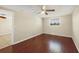 A bright bedroom offers beautiful wood floors and a ceiling fan for added comfort at 1533 Olympia Rd, Venice, FL 34293