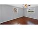 Another bedroom boasts wood floors, ample light and ceiling fan at 1533 Olympia Rd, Venice, FL 34293