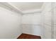 Walk-in closet featuring wood floor, shelves and hanging racks at 1533 Olympia Rd, Venice, FL 34293