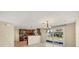 Open concept kitchen and dining area with granite counters and modern lighting at 1533 Olympia Rd, Venice, FL 34293