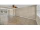 Bright living room featuring tile flooring, ceiling fan, and plenty of natural light at 1533 Olympia Rd, Venice, FL 34293