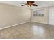 Spacious living room featuring tile floors, neutral paint, and a ceiling fan at 1533 Olympia Rd, Venice, FL 34293