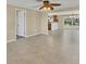 Spacious living room with tile floors, ceiling fan, and open access to the kitchen at 1533 Olympia Rd, Venice, FL 34293