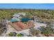 Aerial view of a playground with colorful play structures and shades surrounded by lush greenery at 1533 Olympia Rd, Venice, FL 34293