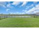 A expansive backyard features a pristine lawn and picturesque pond views at 16411 62Nd E Gln, Parrish, FL 34219