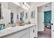 Bright bathroom with double vanity, granite countertops, modern fixtures, and a door to another room at 16411 62Nd E Gln, Parrish, FL 34219