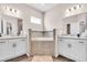 A spacious bathroom includes double vanities, a soaking tub, and modern lighting fixtures at 16411 62Nd E Gln, Parrish, FL 34219