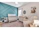 Cozy Bedroom with an accent wall, crib, dresser, and chair, creating a comforting space at 16411 62Nd E Gln, Parrish, FL 34219