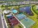 Aerial view of community amenities including a playground, pool, tennis courts, and a basketball court at 16411 62Nd E Gln, Parrish, FL 34219