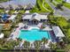Aerial shot showcasing the sparkling community pool surrounded by palm trees and inviting lounge areas at 16411 62Nd E Gln, Parrish, FL 34219