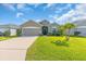 Charming single-story home featuring a well-manicured lawn and a welcoming entrance at 16411 62Nd E Gln, Parrish, FL 34219