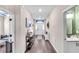Inviting hallway with hard flooring, console table, and direct entry to the half bathroom at 16411 62Nd E Gln, Parrish, FL 34219