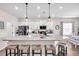 Bright kitchen featuring a large island with seating and modern pendant lighting at 16411 62Nd E Gln, Parrish, FL 34219