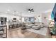 Open-concept living area featuring a large sectional, modern fixtures, and an eat-in kitchen at 16411 62Nd E Gln, Parrish, FL 34219