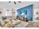 Stylish living room with a feature wall, entertainment center, and comfortable seating at 16411 62Nd E Gln, Parrish, FL 34219
