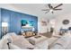 Bright living room featuring a comfortable sofa, ottoman, and a modern TV setup at 16411 62Nd E Gln, Parrish, FL 34219