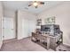 Spacious office area featuring a rustic desk, neutral walls and carpet, and a well-lit area with window at 16411 62Nd E Gln, Parrish, FL 34219