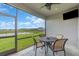 A screened patio features an outdoor dining set with views of the backyard and pond at 16411 62Nd E Gln, Parrish, FL 34219