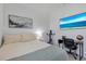 Comfortable bedroom with a bed, desk, and television, perfect for relaxation and productivity at 19801 Fishhawk Trl, Venice, FL 34293
