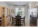 Cozy dining area with table, chairs, and natural light streaming through the window at 19801 Fishhawk Trl, Venice, FL 34293