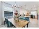A brightly lit dining area with a table and blue chairs, a chandelier, and plenty of natural light at 19801 Fishhawk Trl, Venice, FL 34293