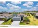 Inviting single-Gathering home featuring manicured lawn, mature landscaping and paver driveway with a water view in the background at 19801 Fishhawk Trl, Venice, FL 34293