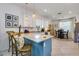 Bright kitchen area featuring bar stool seating at the island, granite countertops and a dining nook at 19801 Fishhawk Trl, Venice, FL 34293