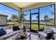 Enjoy serene water views from this screened lanai, furnished with comfortable seating and stylish décor at 19801 Fishhawk Trl, Venice, FL 34293