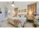 Luxurious bedroom with elegant chandelier, decorative curtains, and ensuite bathroom entrance at 19801 Fishhawk Trl, Venice, FL 34293