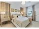 Inviting bedroom featuring a plush bed, stylish decor, and soft natural lighting at 19801 Fishhawk Trl, Venice, FL 34293