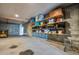 Spacious unfinished basement with concrete floor and walls, offering ample storage with wooden shelving, plus a garage door at 217 22Nd Street Ne Ct, Bradenton, FL 34208